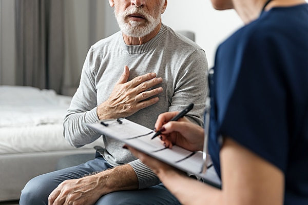  Man touching his heart during consultation