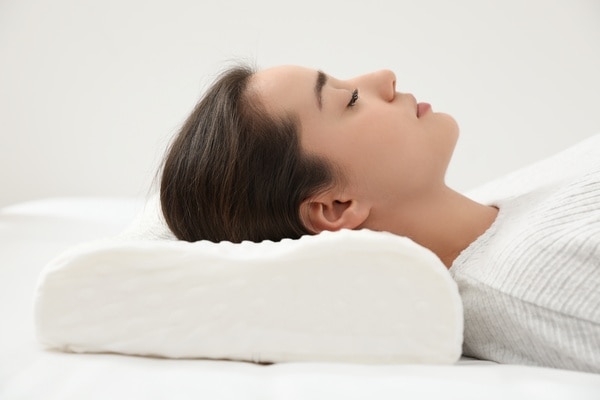  Woman sleeping on back with specialty pillow