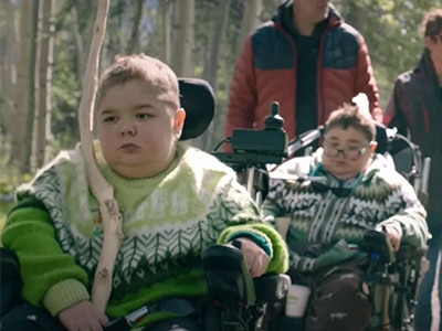 Children with NMD in a wheelchair in nature