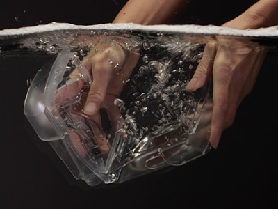 A pair of hands washing a Resmed product