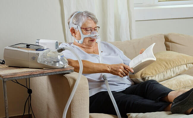 stellar_copd_woman_reading_book_sofa