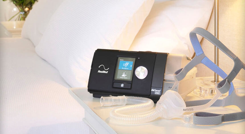 CPAP machine and mask close to bed