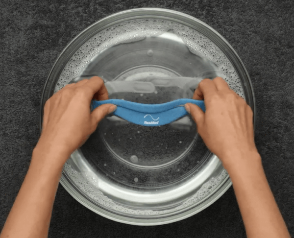 Hands cleaning CPAP mask on regular basis