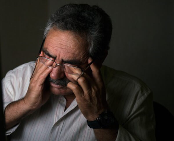 Tired arabic man closing eyes by ResMed